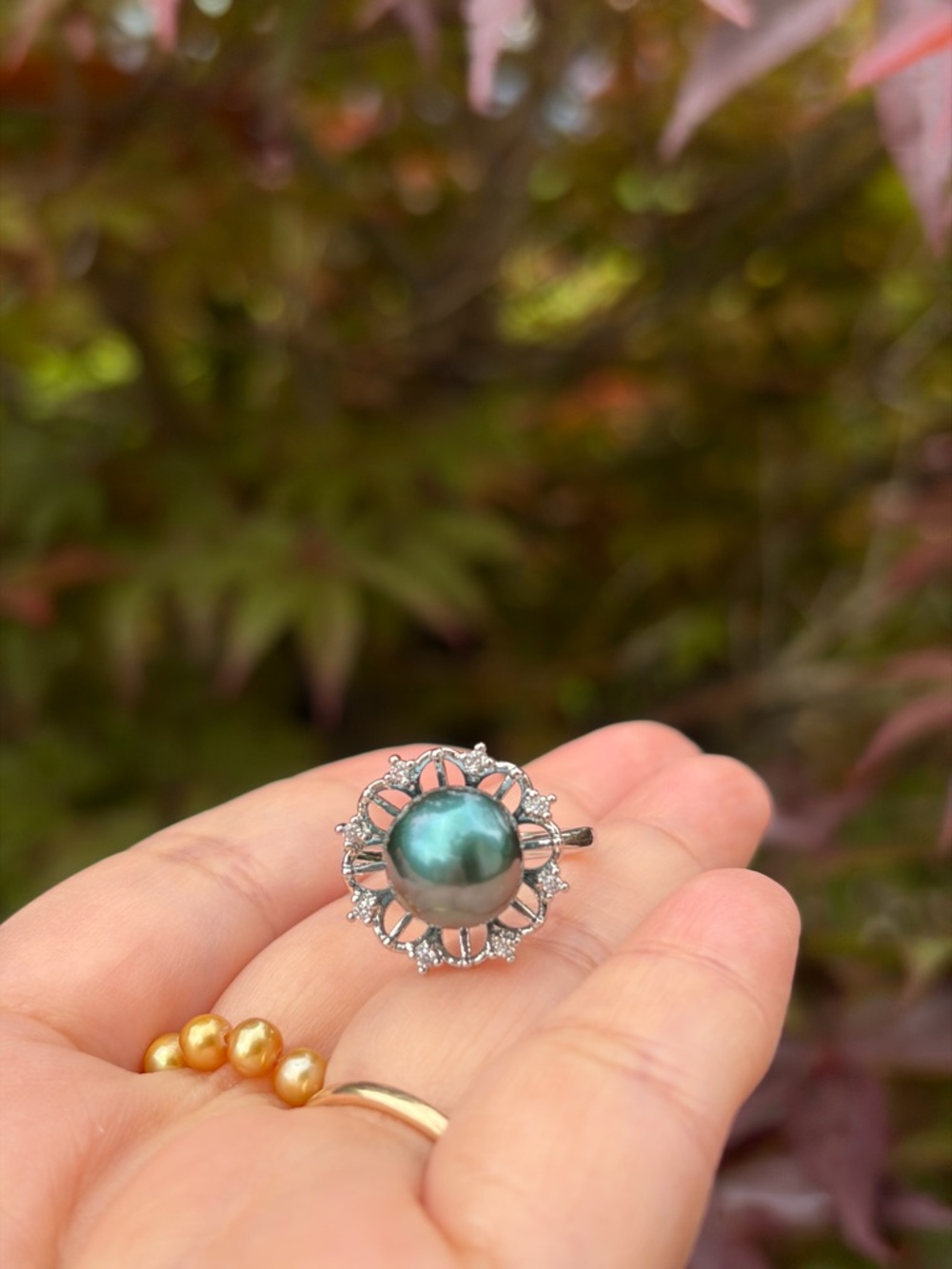 Adjustable ring in Peacock green pearl and Crystal Halo